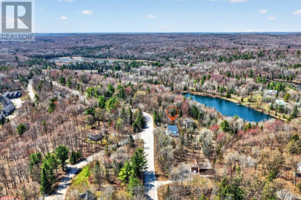 Aerial view of lakefront property with houses and forest - 1616 Skyline Drive Huntsville