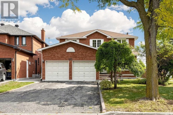 Front exterior of a two-story brick house with a double garage, porch, and manicured lawn. - 162 Venetian Crescent, Vaughan