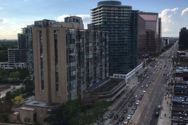 View of city buildings and traffic on a street from a high-rise apartment. - 1628 - 500 Doris Avenue, Toronto