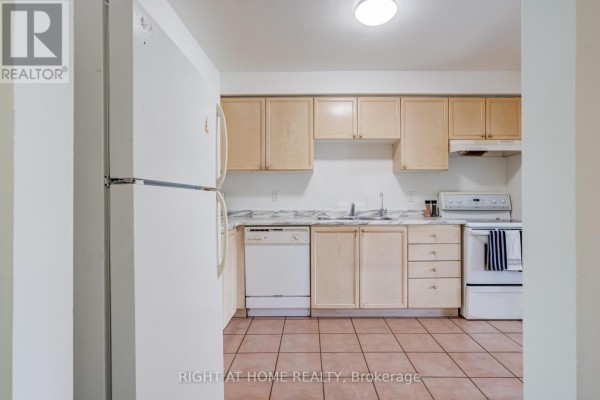 Kitchen with light wood cabinets, white appliances including a refrigerator, dishwasher, stove, and tile flooring. - 163 - 302 College Avenue W, Guelph