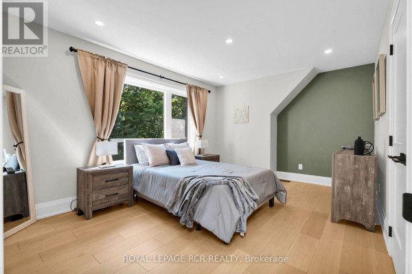 Bedroom with bed, nightstands, dresser, and large window - 163 Confederation Street Halton Hills