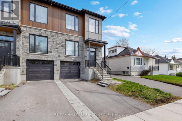View of the exterior of the townhouse and adjacent properties under a blue sky. - 163 Longpre Street, Ottawa