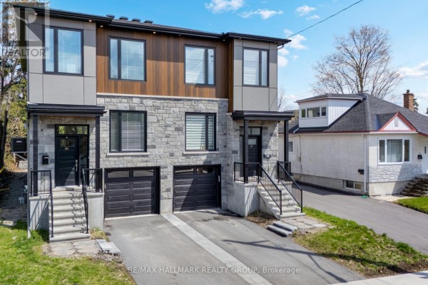 Front facade of a modern semi-detached home with stone and wood paneling. - 163 Longpre Street, Ottawa