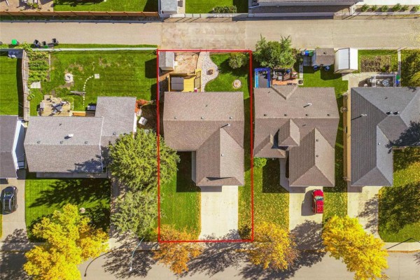Top-down view of the property boundaries outlined in red, showing the house and backyard. - 1631 22nd Street, Brandon