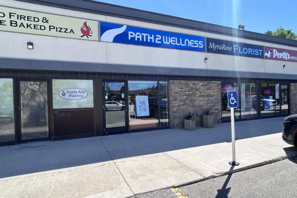 A row of storefronts includes Santa Ana Pizzeria and Path 2 Wellness with brick accents. - 1631 St Mary's Road, Winnipeg