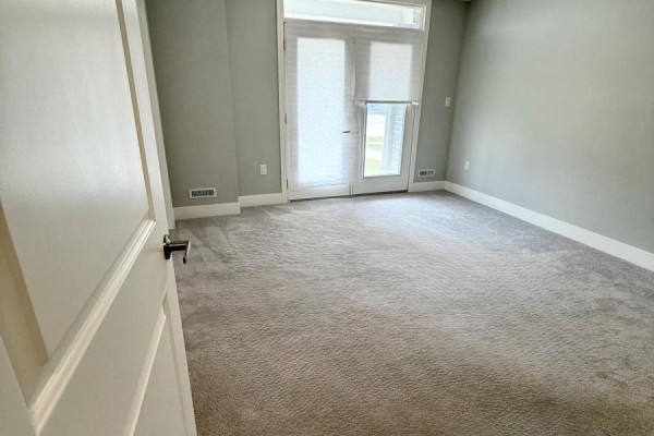Bedroom with gray carpet, white trim, and glass double doors. - 164 - 177 Edgevalley Road, London East