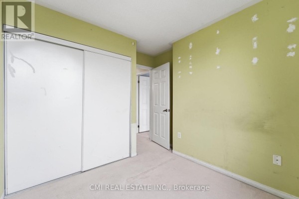 Empty room with lime green walls, a large white sliding closet door, and a white interior door. - 164 - 760 Lawrence Avenue W, Toronto