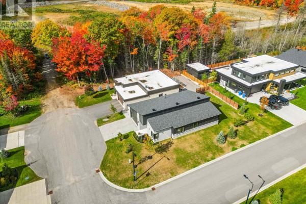 Aerial view of a residential street with modern homes and autumn foliage in North Bay, Ontario. - 164 Sugarbush Street, North Bay