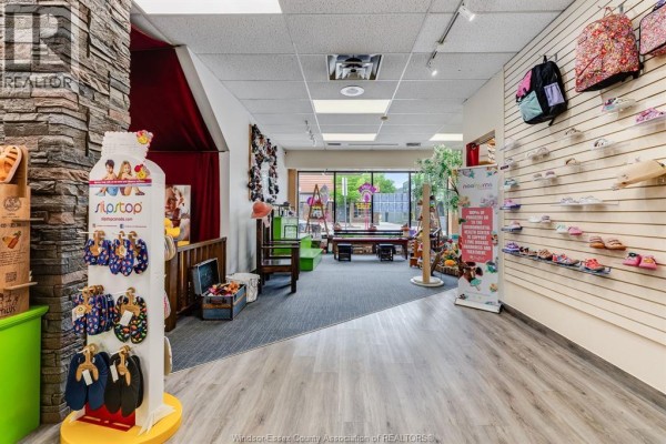 Interior of a children's shoe store with displays, seating, and natural light from windows. - 1643 Ottawa Street, Windsor
