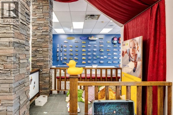 Interior view of a children's shoe store, showing wall displays and wooden accents. - 1643 Ottawa Street, Windsor
