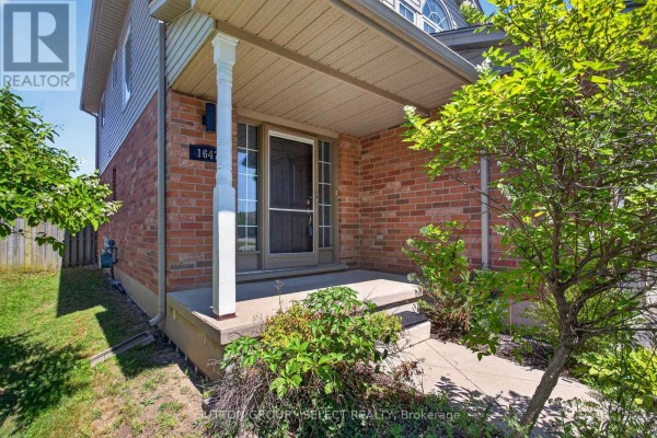 Covered front porch with brick facade, white columns, and a screen door at 1647. - 1647 Bayswater Crescent, London North