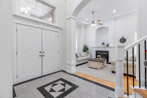 Dining area adjacent to the kitchen with a round glass table, four grey chairs, and light wood cabinetry. - 16488 104a Avenue, Surrey