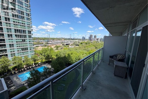 Wooden sauna with glass door and benches, adjacent to white tiled hallway. - 165 Legion Road N Unit# 933, Toronto