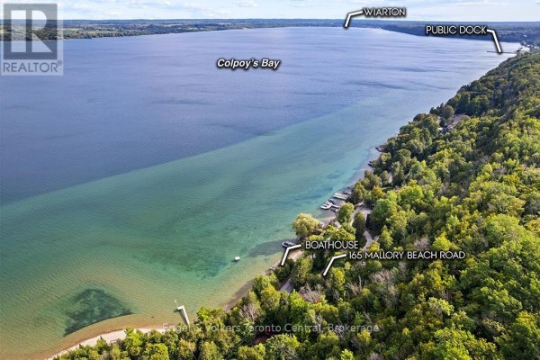 Aerial view of waterfront property with boathouse on Colpoy's Bay - 165 Mallory Beach Road South Bruce Peninsula
