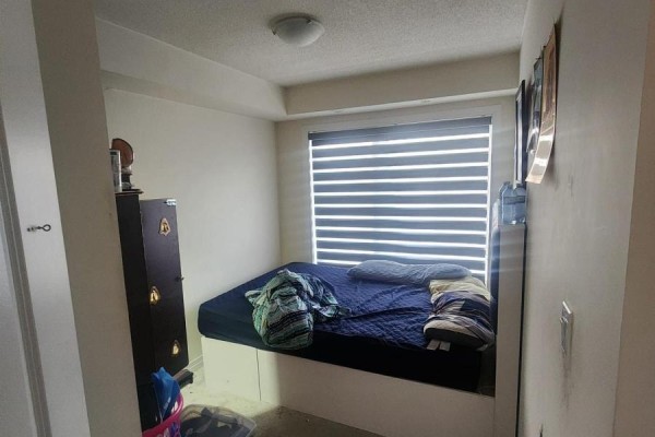 Small bedroom with a mattress on the floor, dark dresser, and a window with blinds. - 20 - 165 Tapscott Road, Toronto