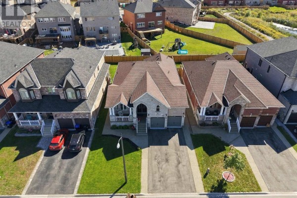 Aerial view of the property at 1650 Rizzardo Crescent, Innisfil, showing the front facade and surrounding houses. - 1650 Rizzardo Crescent, Innisfil