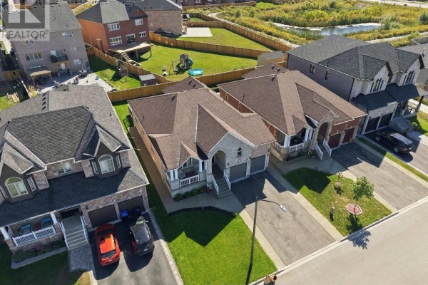 Overhead drone view of residential homes on Rizzardo Crescent, Innisfil, showcasing roof lines and backyard fences. - 1650 Rizzardo Crescent, Innisfil