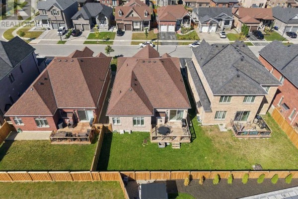 Aerial perspective of backyard fences, green lawns, and neighboring houses on Rizzardo Crescent in Innisfil. - 1650 Rizzardo Crescent, Innisfil