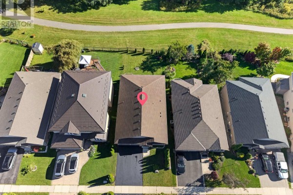 Aerial view of the property's backyard and roof, with a walking path behind the fence. - 1653 Cedarcreek Crescent, London North