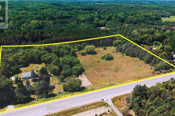 Aerial view of a large property lot with a house, trees, and a road in the foreground. - 16558 Highway 48, Whitchurch Stouffville