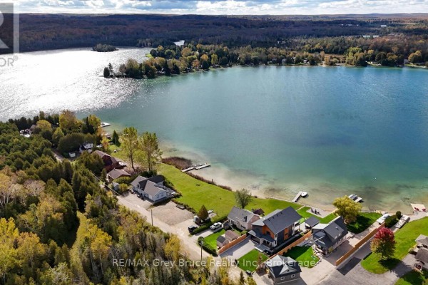 Aerial view of 166 Country Side Drive, Chatsworth, showing the property nestled among trees by a lake. - 166 Country Side Drive, Chatsworth