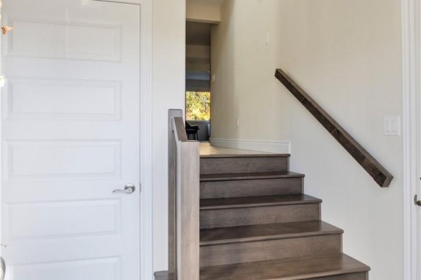 View looking up a modern wooden staircase with white doors on the left. - 166 Eclipse Crescent, Sudbury