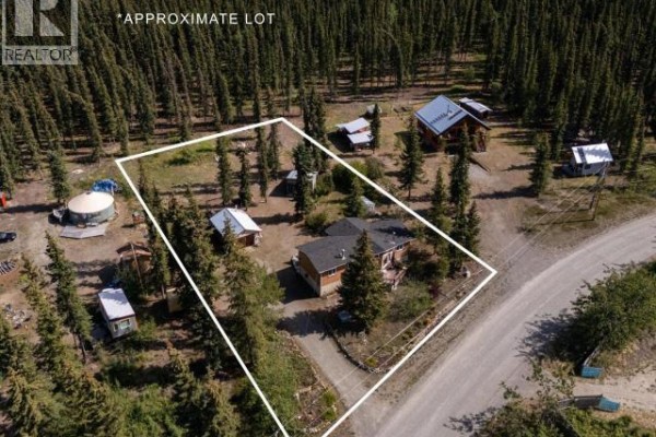 Aerial view of a property showing the main house and several outbuildings within a white boundary line. - 166 Judas Creek Drive, Whitehorse South