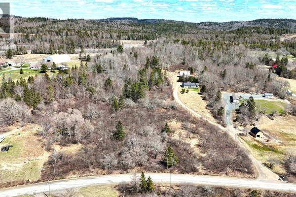 Aerial view of a rural landscape with scattered houses, wooded areas, and rolling hills. - 166 Kerrs Ridge Road, Bocabec
