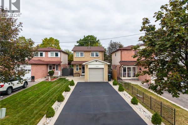 Aerial view of a detached house with a driveway, lawn, and neighboring homes. - 166 Martindale Crescent, Brampton
