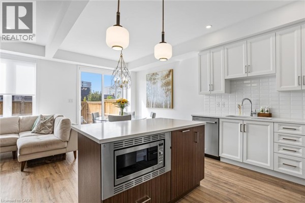 Open-concept kitchen and living area with a large island and modern appliances. - 166 Mount Albion Road Unit# 25, Hamilton