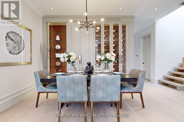 Dining room with a long table, six chairs, and a large wine cabinet with glass doors. - 168 Glenvale Boulevard, Toronto
