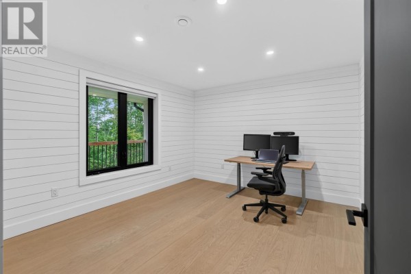 Home office with white shiplap walls, light wood floor, and a desk with monitors. - 1685 Kingston Road, Rte 323, Kingston