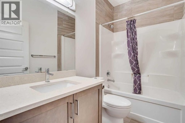 A room with a dark upright piano, bench, music stand, and an ensuite bathroom. - 169 Beaveridge Close, Fort Mcmurray