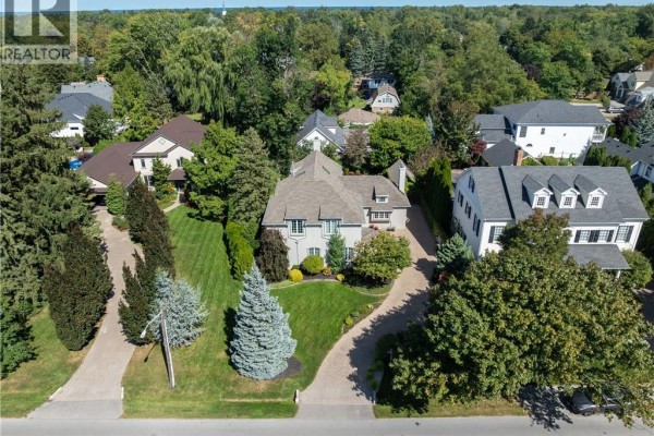 Aerial view of the property at 169 John Street W, Niagara On The Lake, surrounded by trees and other houses. - 169 John Street W, Niagara On The Lake