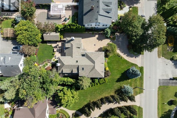 Overhead aerial view of the house and backyard featuring a paved patio and green lawn. - 169 John Street W, Niagara On The Lake