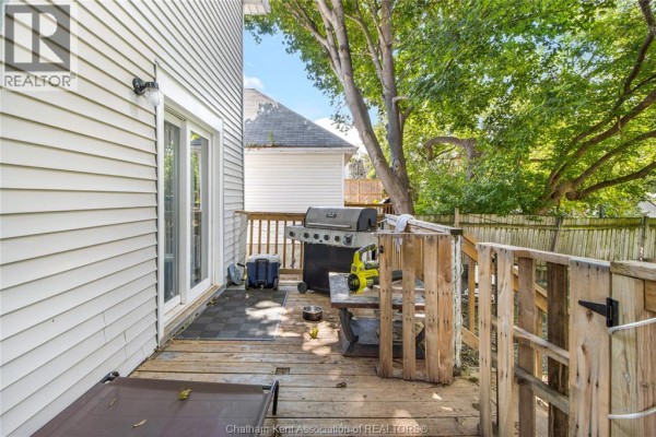 Backyard deck with grill, cooler, and seating - 169 Lorne Avenue Chatham