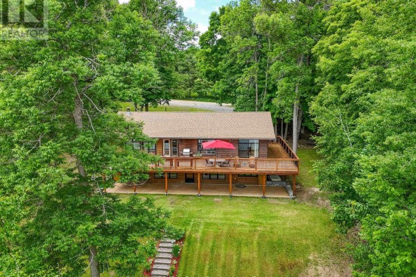 Aerial view of a wooden house with deck and surrounding trees. - 169 Odd's Drive, Parry Sound Remote Area