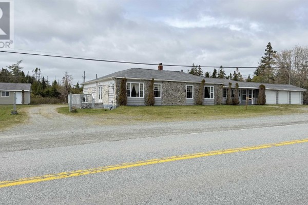 Small bathroom with white tiled walls, toilet, and a clawfoot bathtub. - 16989 Highway 7, Pleasant Harbour