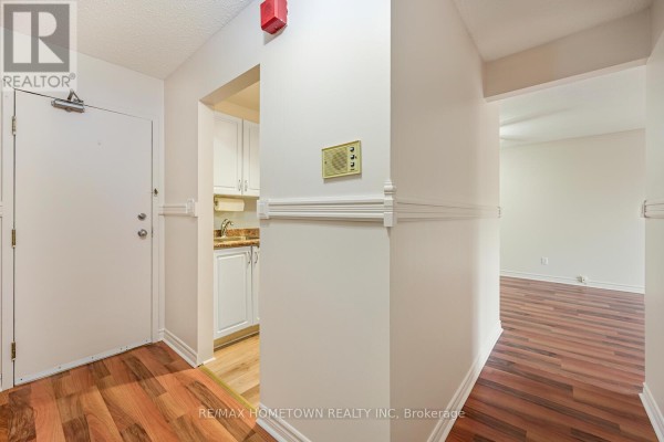 Two-bedroom apartment floor plan showing living room, dining room, kitchen, and bathroom. - 17 - 6 Charlotte Place, Brockville