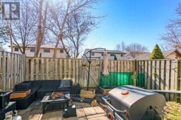 Fenced backyard with outdoor seating, grill, and fire pit - 17 - 711 Osgoode Drive London South