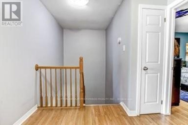 Hallway with wooden banister and white doors - 17 - 711 Osgoode Drive London South