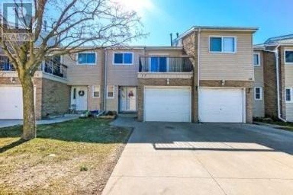 Townhouse exterior with garages and balcony - 17 - 711 Osgoode Drive London South