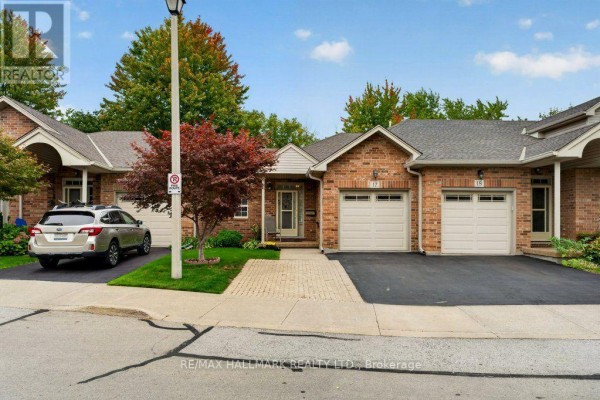 Front view of brick townhouses with garages and mature trees. - 17 - 99 Linwell Road, St  Catharines