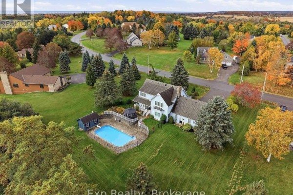 Aerial view of a light blue house with a swimming pool and covered patio in the backyard. - 17 Forest Hill Drive, Hamilton Township