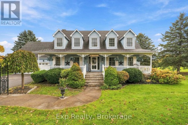 View from the covered front porch with stone flooring, white railing, and wicker chairs. - 17 Forest Hill Drive, Hamilton Township