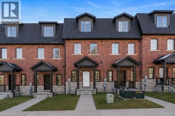 Front exterior of red brick townhouse with peaked dark grey roof. - 17 James Street, Georgetown