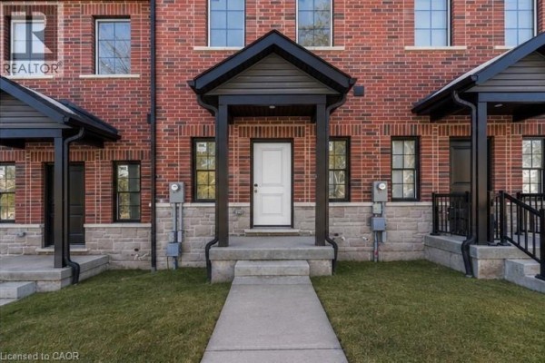 Close-up of red brick townhouse entrance with light grey stone base. - 17 James Street, Georgetown