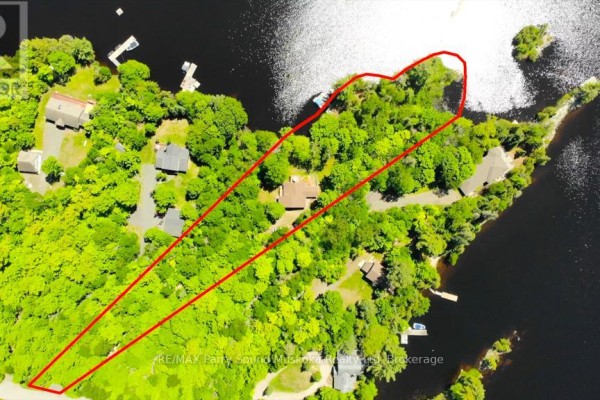 Aerial view of a waterfront property with a house and surrounding trees, outlined in red. - 17 Lizzie's Lane, Mckellar