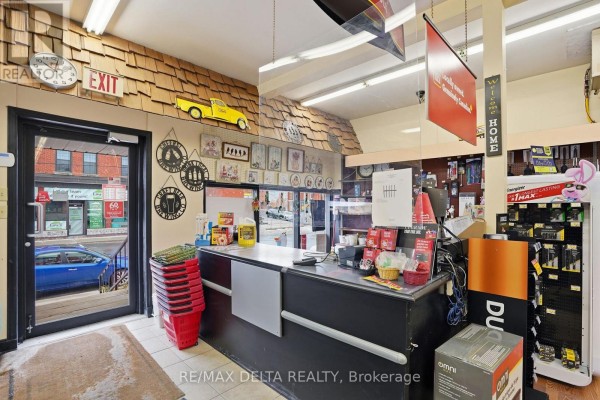 Interior view of the checkout area with a counter, shelves, and various products displayed. - 17 Main Street E, Champlain