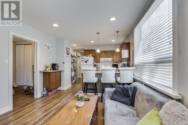 Kitchen with white refrigerator, wood cabinets, white stove, and stainless steel sink. - 17 Mcdonald Avenue, London North
